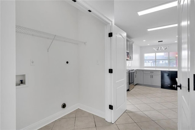 7721 Bullard Ave, New Orleans, LA 70128 - laundry room featuring laundry area, hookup for a washing machine, light tile patterned flooring, hookup for an electric dryer, and a notable chandelier