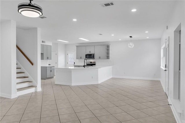 7721 Bullard Ave, New Orleans, LA 70128 - kitchen featuring open shelves, visible vents, gray cabinets, appliances with stainless steel finishes, and a sink