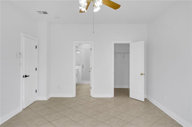 7721 Bullard Ave, New Orleans, LA 70128 - unfurnished bedroom with light tile patterned floors, a closet, ensuite bath, a spacious closet, and visible vents