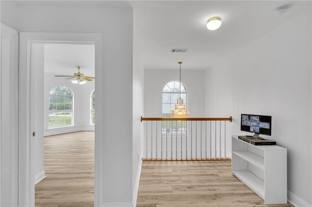 7721 Bullard Ave, New Orleans, LA 70128 - hallway featuring visible vents, baseboards, and light wood-style flooring