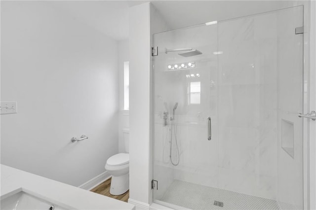 7721 Bullard Ave, New Orleans, LA 70128 - bathroom featuring a marble finish shower, baseboards, toilet, and wood finished floors