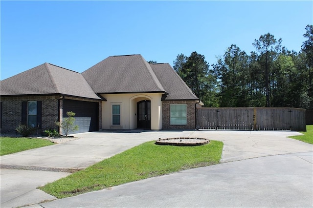 23620 Madisonville Ct, Ponchatoula, LA 70454 - french country inspired facade featuring a shingled roof, concrete driveway, and an attached garage