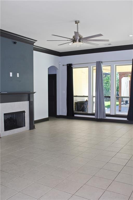 23620 Madisonville Ct, Ponchatoula, LA 70454 - unfurnished living room featuring a fireplace, light tile patterned floors, a ceiling fan, ornamental molding, and arched walkways