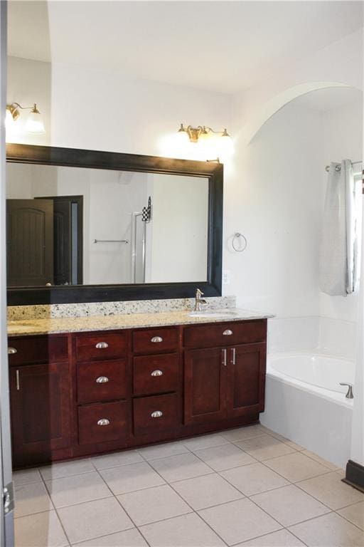 23620 Madisonville Ct, Ponchatoula, LA 70454 - full bath with tile patterned floors, a bath, double vanity, and a sink