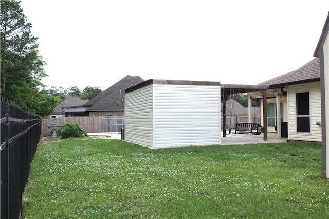 23620 Madisonville Ct, Ponchatoula, LA 70454 - view of yard featuring an outdoor structure, a patio, and a fenced backyard