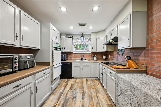 74307 Jack Lloyd Rd, Abita Springs, LA 70420 - kitchen featuring visible vents, dishwasher, a sink, cooktop, and under cabinet range hood
