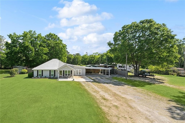 view of front of home featuring driveway, a front yard, and covered porch