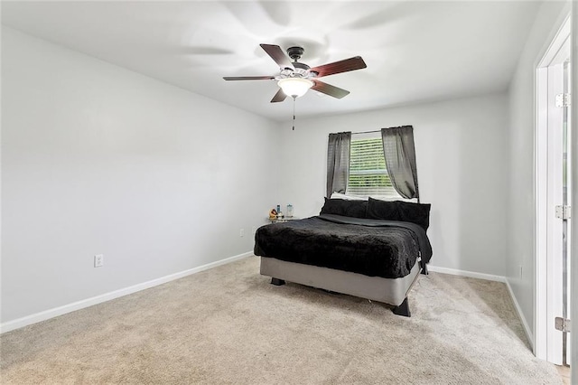 carpeted bedroom with baseboards and a ceiling fan