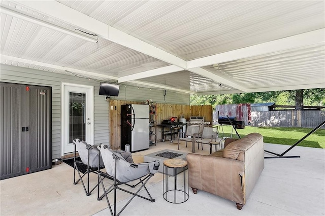 view of patio / terrace featuring a fire pit, fence, and area for grilling