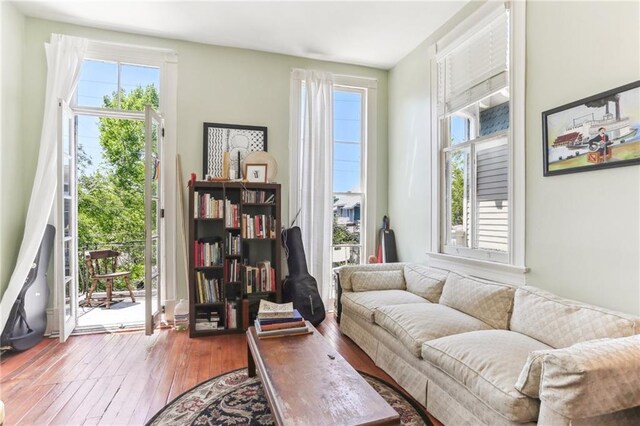 sitting room with wood-type flooring and plenty of natural light