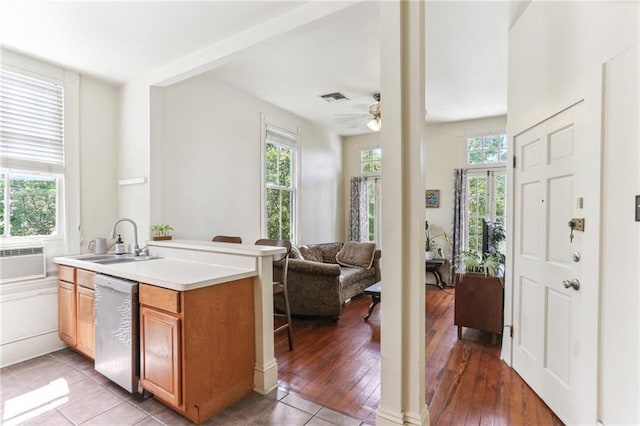 kitchen with dishwasher, a sink, visible vents, and plenty of natural light