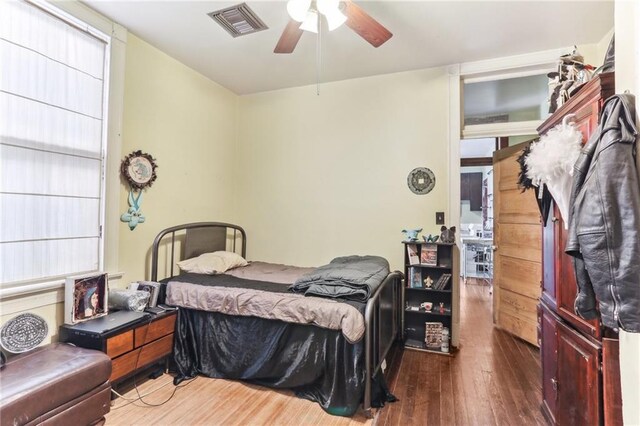 bedroom featuring visible vents, ceiling fan, and hardwood / wood-style floors