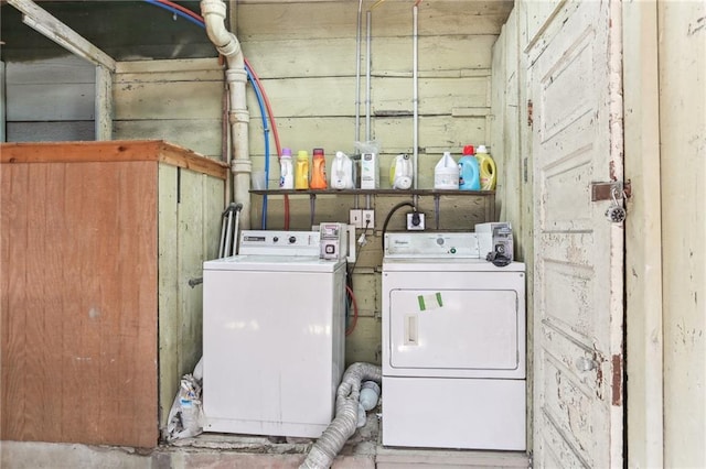 clothes washing area featuring independent washer and dryer and laundry area