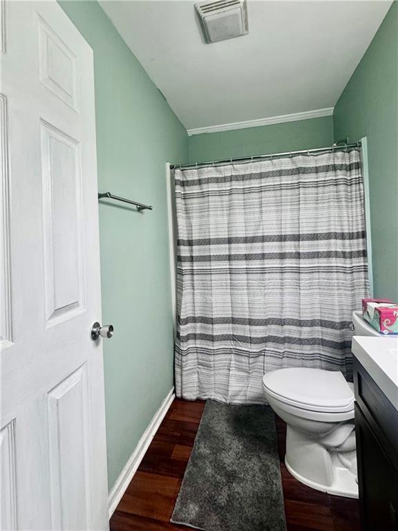 3420 Willow St, New Orleans, LA 70115 - bathroom featuring wood finished floors, vanity, curtained shower, and crown molding