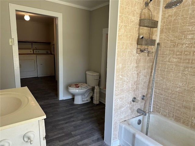 25821 Elsie Gill Rd, Holden, LA 70744 - full bathroom with independent washer and dryer, ornamental molding, toilet, wood finished floors, and washtub / shower combination