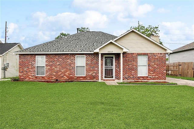 ranch-style house with brick siding, a shingled roof, a front lawn, and fence