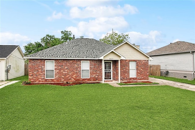 ranch-style house with fence, a shingled roof, a front yard, and brick siding