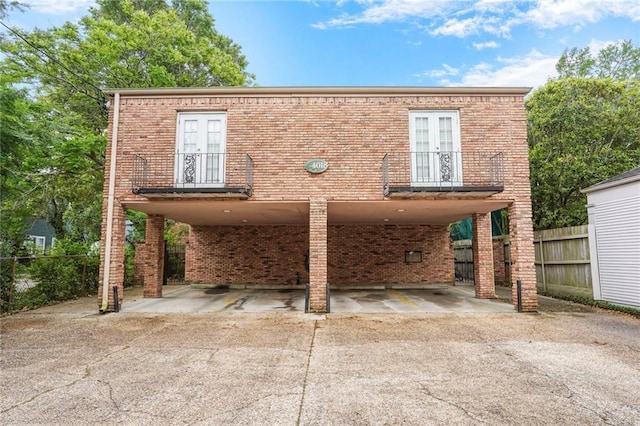 4018 Pitt St, New Orleans, LA 70115 - view of front of property with concrete driveway, brick siding, and french doors