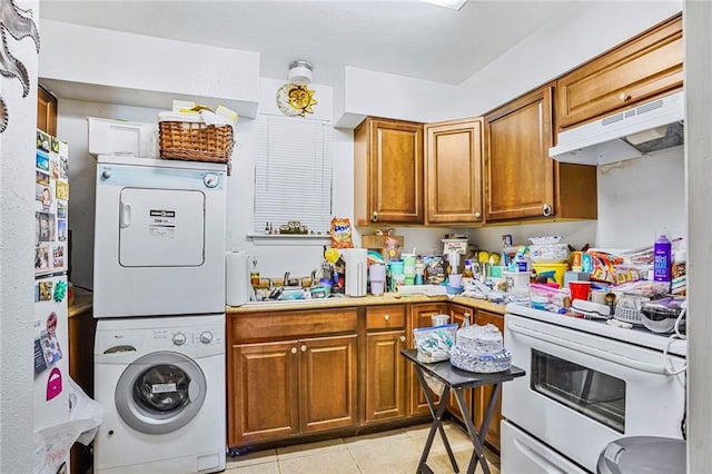 4018 Pitt St, New Orleans, LA 70115 - interior space with stacked washer and dryer, under cabinet range hood, light tile patterned flooring, electric stove, and brown cabinets