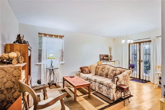 4018 Pitt St, New Orleans, LA 70115 - living area featuring light wood-type flooring, an inviting chandelier, and plenty of natural light