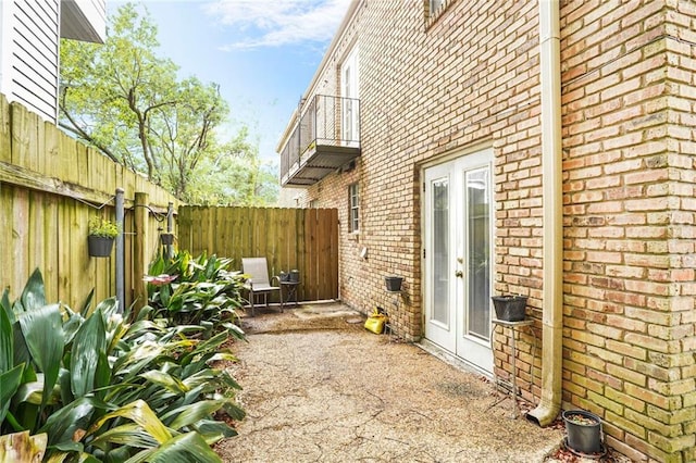 4018 Pitt St, New Orleans, LA 70115 - view of home's exterior with a patio, brick siding, and a fenced backyard
