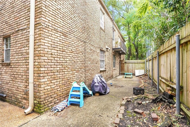 4018 Pitt St, New Orleans, LA 70115 - view of property exterior featuring a fenced backyard and brick siding