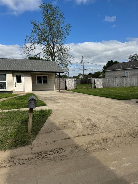 exterior space with concrete driveway and fence