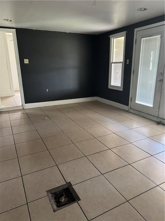 entrance foyer with baseboards and light tile patterned flooring
