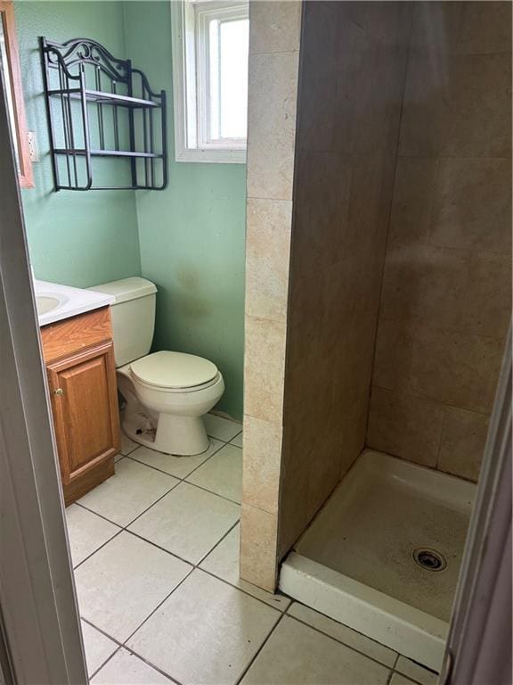 bathroom featuring a shower stall, tile patterned floors, vanity, and toilet