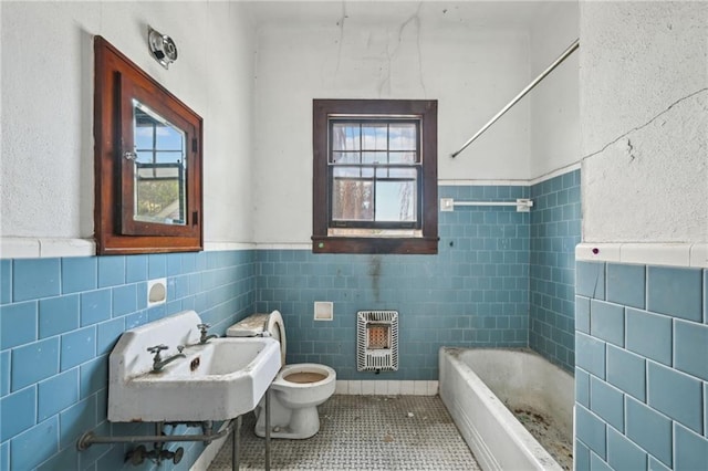 1318 Dublin St, New Orleans, LA 70118 - bathroom featuring tile walls, a healthy amount of sunlight, and heating unit