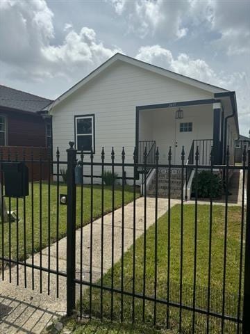 2417 Eagle St, New Orleans, LA 70118 - view of gate featuring a fenced front yard and a lawn