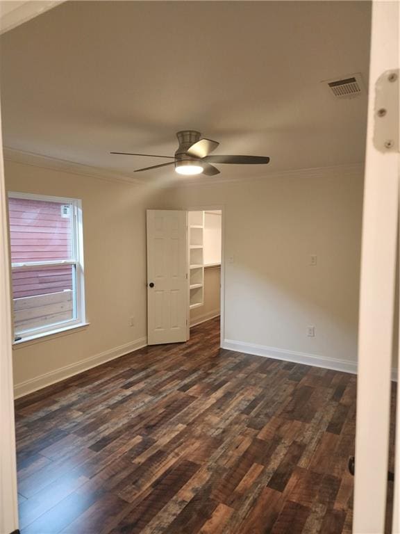2417 Eagle St, New Orleans, LA 70118 - empty room featuring dark wood-type flooring, crown molding, and visible vents