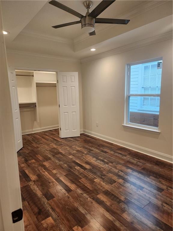 2417 Eagle St, New Orleans, LA 70118 - unfurnished bedroom featuring crown molding, dark wood-type flooring, a closet, a raised ceiling, and baseboards