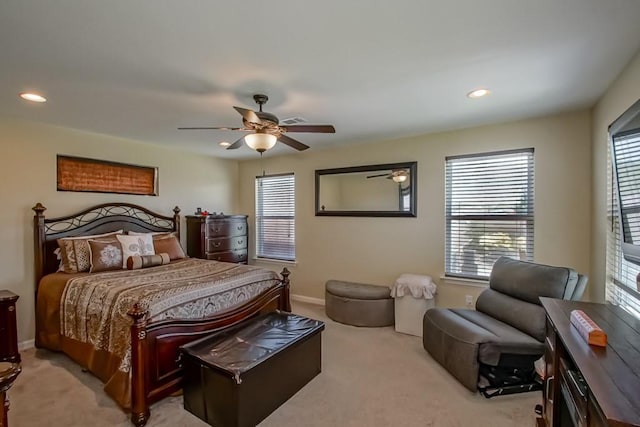 bedroom with multiple windows, baseboards, and light carpet