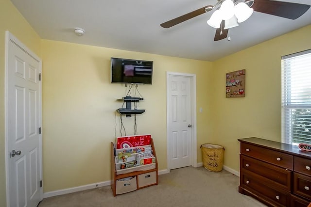 rec room featuring baseboards, a ceiling fan, and carpet flooring