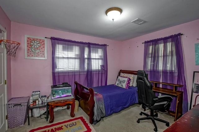 carpeted bedroom featuring visible vents