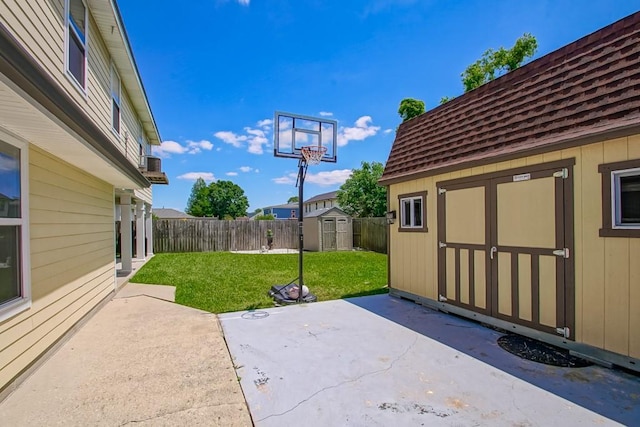 view of patio / terrace featuring a fenced backyard, an outdoor structure, and a storage unit