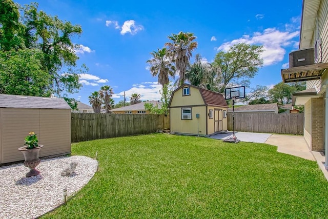 view of yard featuring a fenced backyard, an outbuilding, and a storage unit