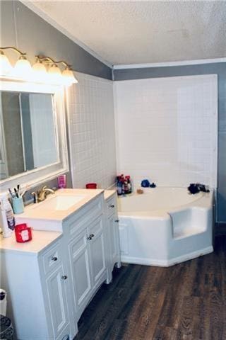 69476 S River Rd, Kentwood, LA 70444 - bathroom with a bath, a textured ceiling, wood finished floors, and lofted ceiling