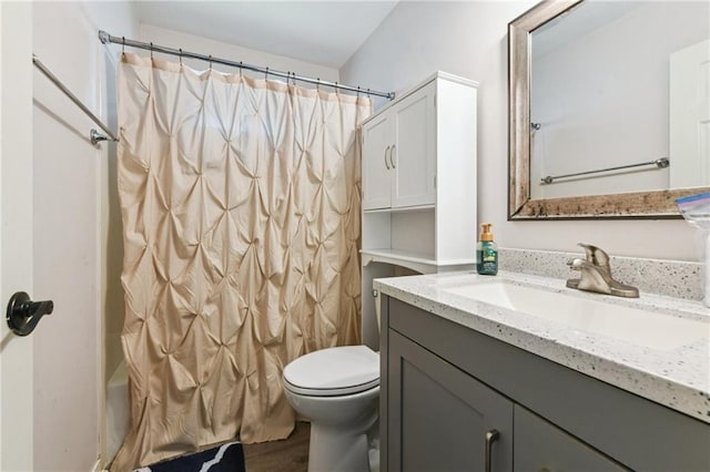 full bathroom featuring shower / bath combo, toilet, vanity, and wood finished floors