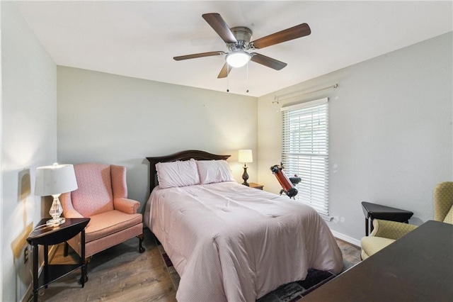 bedroom with baseboards, a ceiling fan, and wood finished floors