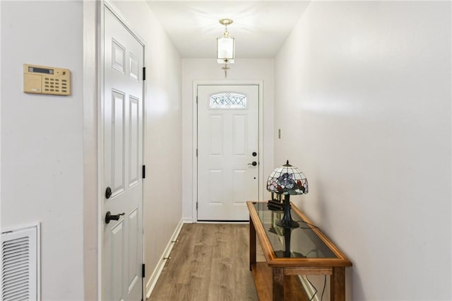 entryway with visible vents, baseboards, and light wood-type flooring