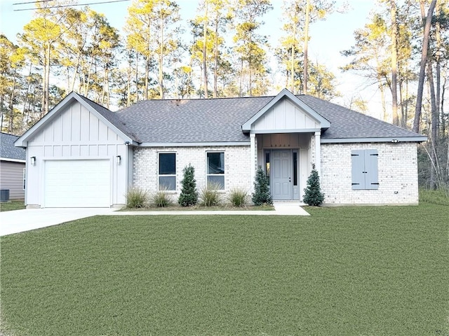view of front of home with driveway, brick siding, a garage, board and batten siding, and a front yard