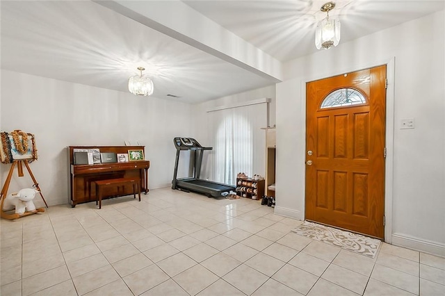 entrance foyer featuring a chandelier, light tile patterned floors, baseboards, and visible vents