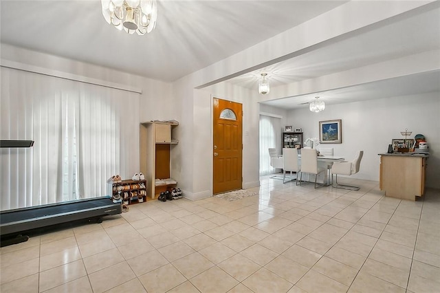 living area featuring baseboards, an inviting chandelier, and light tile patterned flooring
