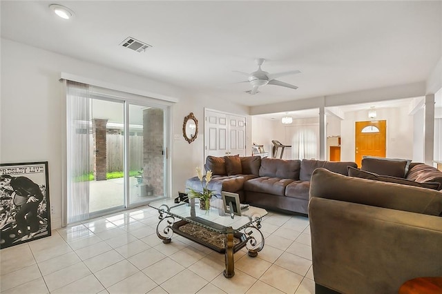 living area with light tile patterned floors, visible vents, and a ceiling fan