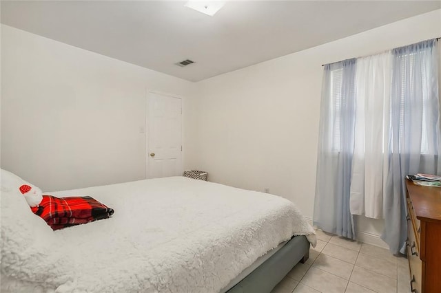 bedroom with light tile patterned floors and visible vents
