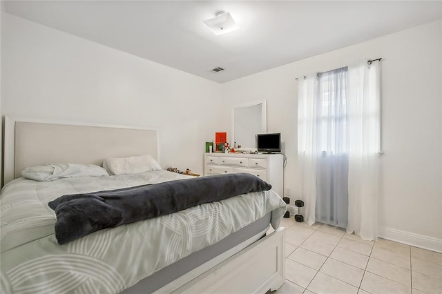 bedroom featuring visible vents, baseboards, and light tile patterned flooring