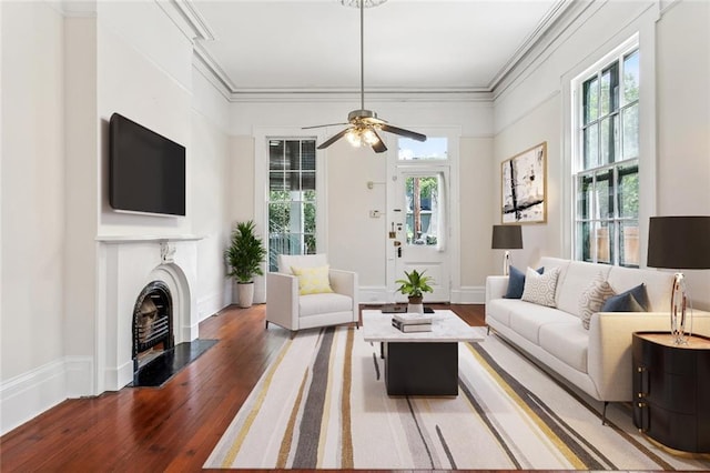 101012 Philip St, New Orleans, LA 70130 - living room featuring healthy amount of natural light, wood finished floors, a fireplace with flush hearth, a ceiling fan, and ornamental molding