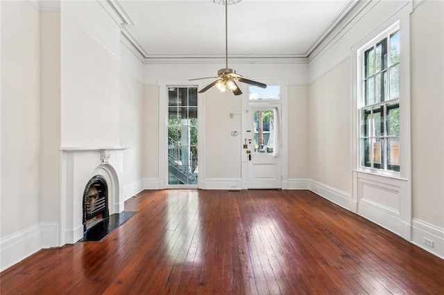 101012 Philip St, New Orleans, LA 70130 - unfurnished living room featuring healthy amount of natural light, hardwood / wood-style floors, a fireplace with flush hearth, and ornamental molding